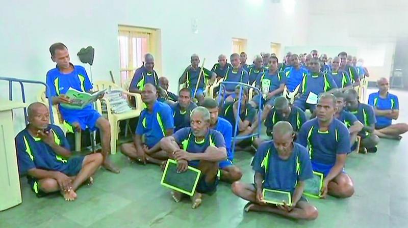Some of the beggars who were picked up by the TS prisons department sit inside the Anand Ashram at Cherlapally.