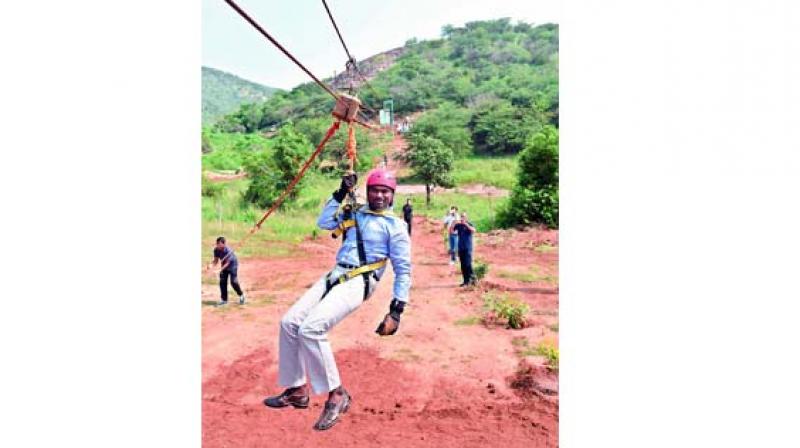 IAS officer Ronald Rose, the District Collector of Mahabubnagar, trying out ziplining facility at the park before formal inauguration