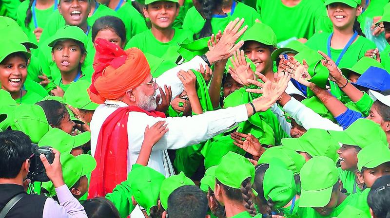 Prime Minister Narendra Modi interacts with children during Independence Day celebrations at the Red Fort, in New Delhi on Wednesday. (Photo: AP)