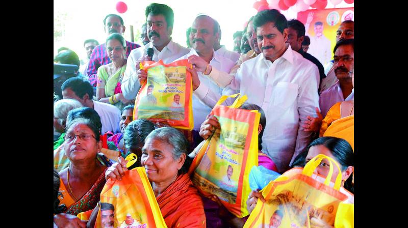 Ministers Devineni Umamaheswara Rao, P. Pullarao, MLA Bonda Uma distribute Christmas Chandranna Kanuka at Kasturibaipet in Vijayawada on Wednesday. (Photo: DC)