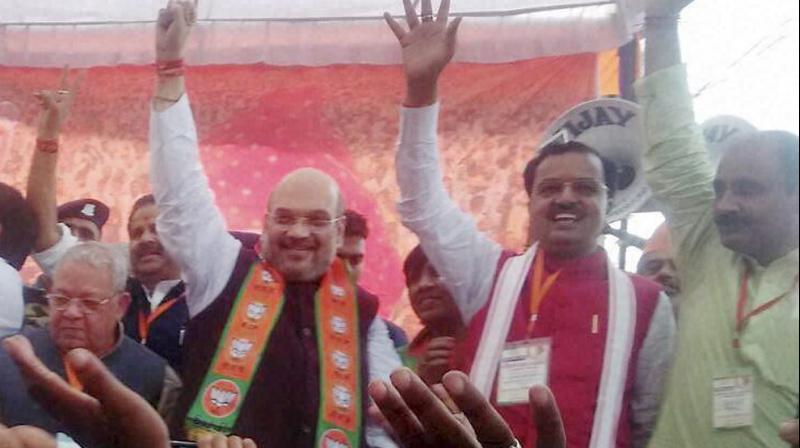 BJP National President Amit Shah with his supporters during an election rally for UP elections in Saharanpur. (Photo: PTI)