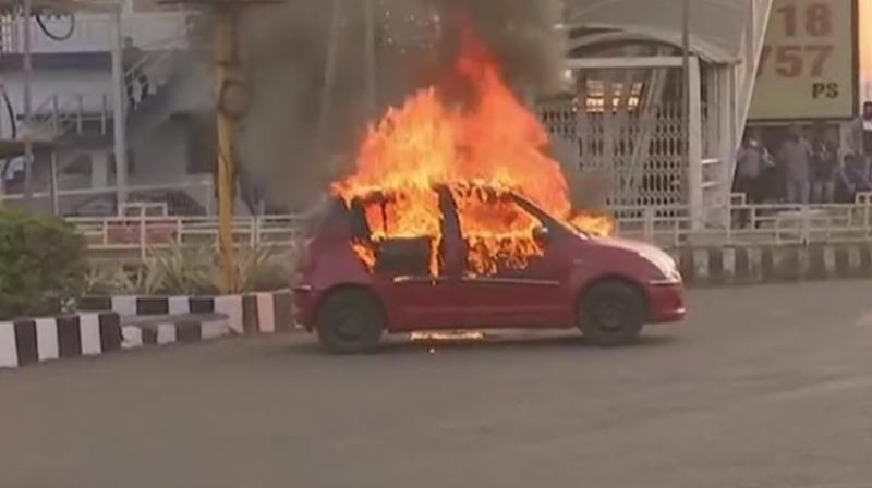 Karni Sena members accidentally torched their own members vehicle while protesting in Bhopal. (Twitter Screengrab/ ANI)