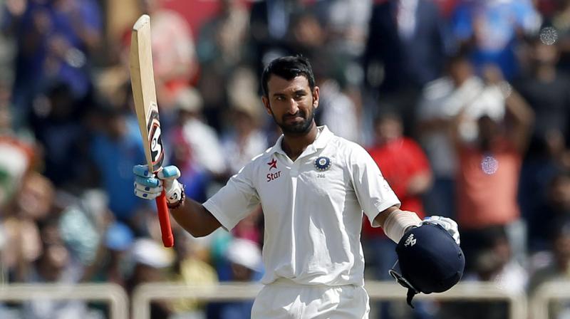 Cheteshwar Pujara has brought up his 11th Test ton and is leading Indias charge after Australia scored 451 runs batting first. (Photo: AP)