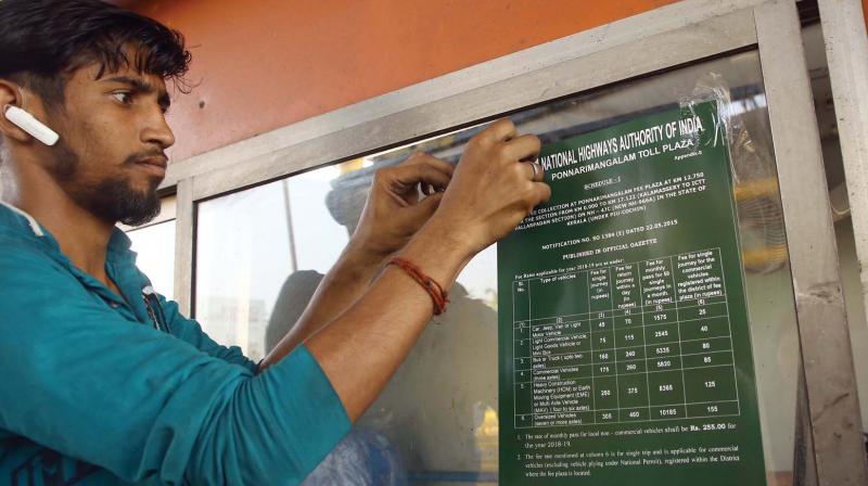 A worker makes last minute arrangements for the toll booth on Container Road in Kochi on Wednesday. 	(DC)