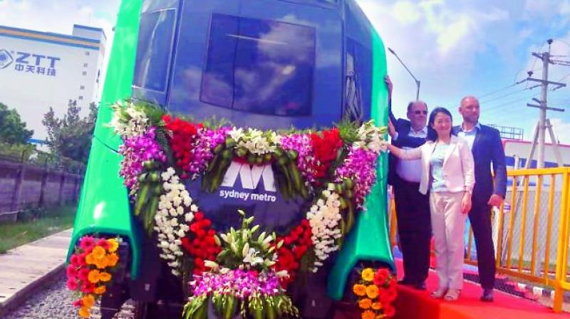 Officials of the Sydney Metro with the Metropolis train manufactured by Alstom facility at Sri City in Nellore on Thursday. 	(Photo: DC)