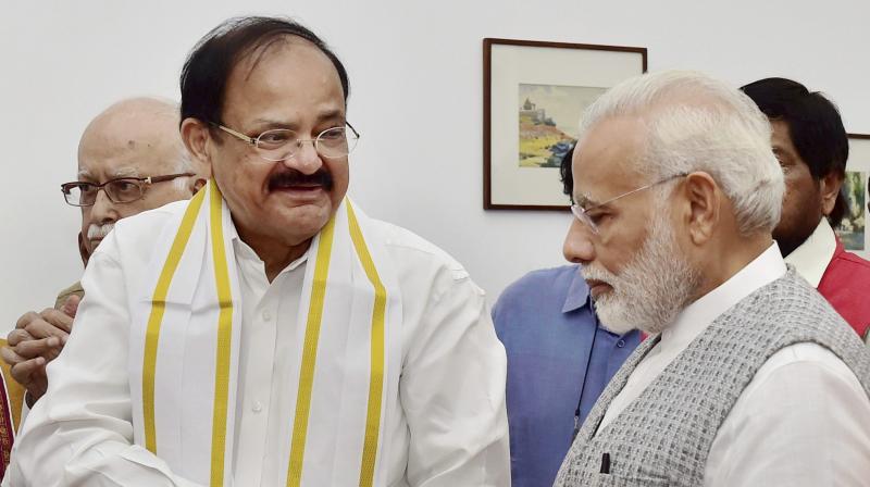 NDAs vice-presidential candidate Venkaiah Naidu being greeted by Prime Minister Narendra Modi after he filed his nomination papers at Parliament in New Delhi on Tuesday. (Photo: PTI)