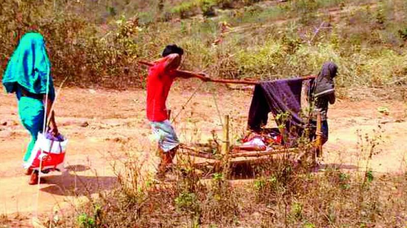 A pregnant lady being carried on a cot to the hospital.