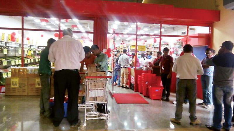 Customers line up outside a store at the Baiyappanahalli Metro Station.