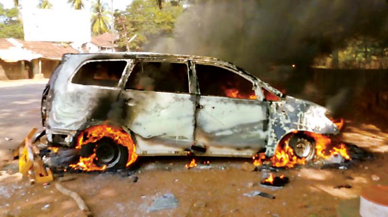 The vehicle of IGP (western range) Hemanth Nimbalkar which was set on fire by protesters in Kumta on Monday. (Photo: DC)