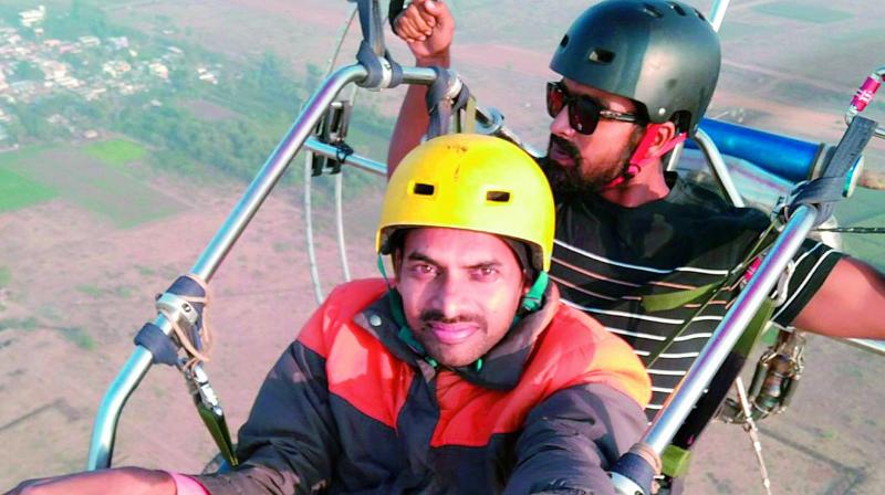 Youngsters take a selfie at the para-motoring near Ferry in Vijayawada on Tuesday. (Photo: DC)