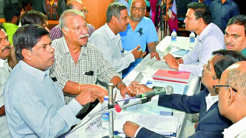 Members argue with the chair at the Hyderabad Cricket Associations Special General Meeting at the Rajiv Gandhi International Cricket Stadium on Sunday.