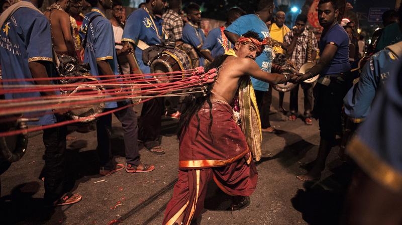 Devotees pierced their faces with tridents or hung multiple hooks and chains from their bodies in an act of penance. (Photo: