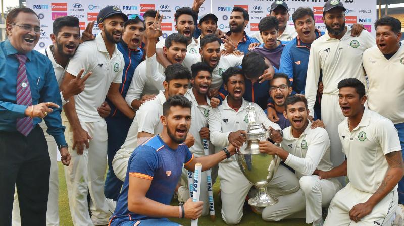 Vidarbha players celebrate with the trophy after winning the Ranji Trophy final against Delhi by 9 wickets. (Photo:PTI)