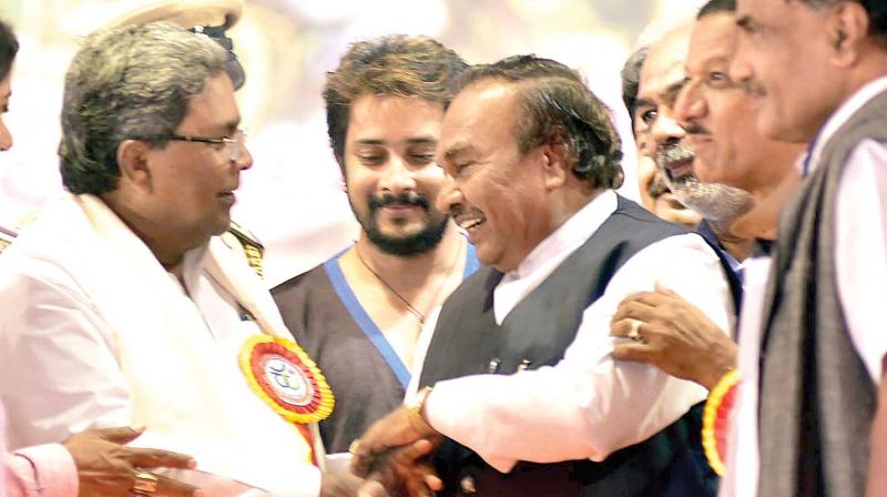 CM Siddaramaiah and BJP leader K.S. Eshwarappa at a programme organised by Karnataka Kuruhina Shetty Janajagruthi Mahasabha in Hassan on Sunday (Photo: KPN)
