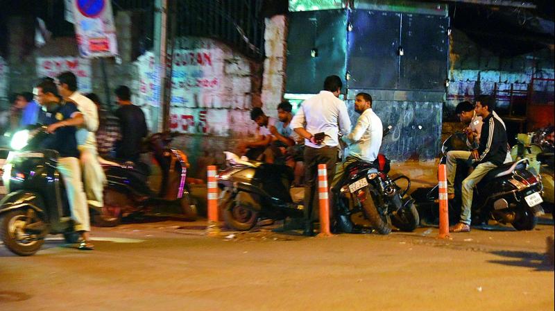 People park their vehicles near poles, which residents claim have been erected by traffic police to help an Irani tea stall at Shantinagar in Masab Tank. (Photo: DC)