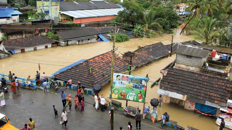 People watch in fear as heavy rains submerged the Sundaram Colony in Palakkad on Thursday. (Photo: DC)