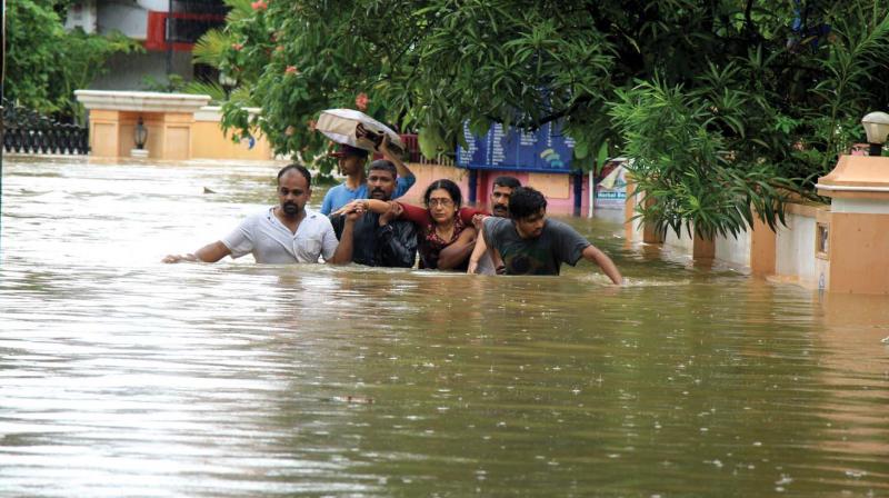 A woman being shifted to safety after Aishwarya Colony at Olavakkode in Palakkad got inundated on Thursday.