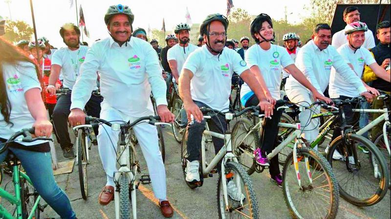 Serilingampally MLA Arekapudi Gandhi, GHMC commissioner B. Janardhan Reddy and GHMC West zone commissioner Hari Chandana Dasari participate in the cyclothon at Gachibowli on Saturday.