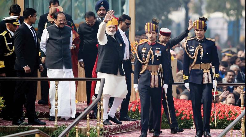 Prime Minister Narendra Modi (C) waves to spectators at the end of Indias 69th Republic Day  Parade in New Delhi on Friday 	AFP