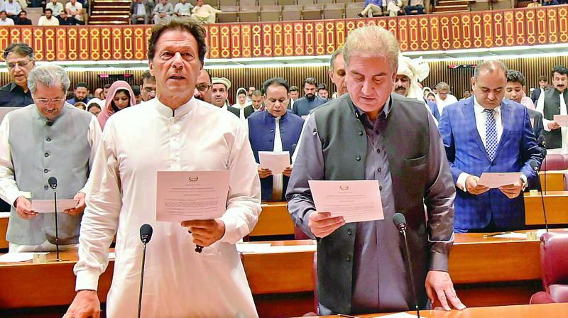 Newly-elected parliamentarian Imran Khan takes the oath of office in Islamabad, Monday. 	 (Photo:AP/PTI)