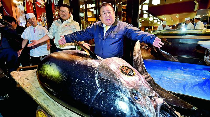 Kiyoshi Kimura, president of sushi restaurant chain Sushi-Zanmai, with the 278kg bluefin tuna at his main restaurant in Tokyo on Saturday. (Photo: AFP)