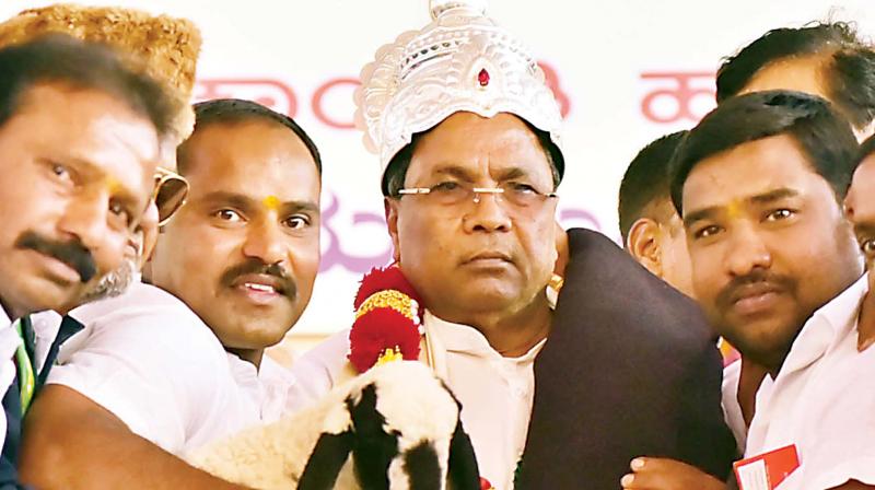 Chief Minister Siddaramaiah being presented with a crown, goat and a blanket at Kadur on Friday  	 KPN