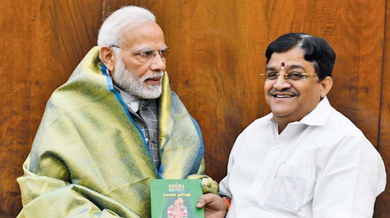 AIADMK Rajya Sabha member Dr V. Maitreyan called on Prime Minister Narendra Modi at New Delhi on Wednesday and presented a copy of his book on Sri Aandal Natchiyars Thiruppavai. (Photo: DC)