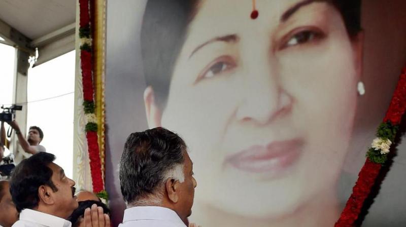 Tamil Nadu Chief Minister K Palanisamy and his deptuy, O Panneerselvam, pay tributes at the memorial of J Jayalalithaa following a merger of their factions in Chennai on Monday. (Photo: PTI)