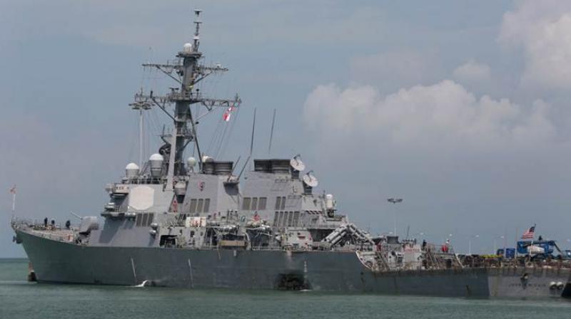 The Guided-missile destroyer USS John S. McCain (DDG 56) is moored pier side at Changi naval base in Singapore following a collision with the merchant vessel Alnic MC Monday. (Photo: AP)