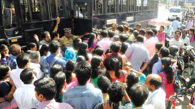 Police help stranded passengers by arranging their department vans for transport on hartal day in Thiruvananthapuram on Thursday. (Photo:  DC)