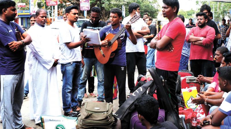 A batch of people who came to attend a meditation camp at Edakochi decided to have a musical session on the premises of South Railway station on account of the non-availability of vehicles due to the 12-hour hartal. 	(Photo: ARUNCHANDRA BOSE)