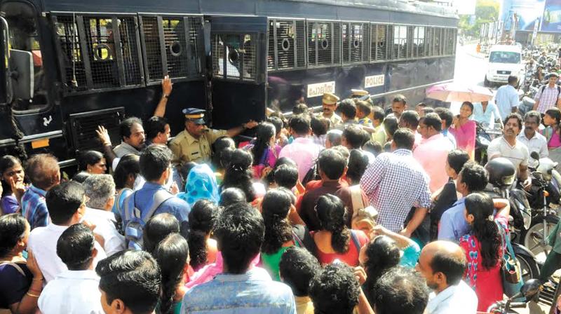Police comes to the rescue of stranded passengers by arranging their department vans on hartal day in Thiruvananthapuram on Thursday. (Photo: A.V. MUZAFAR)