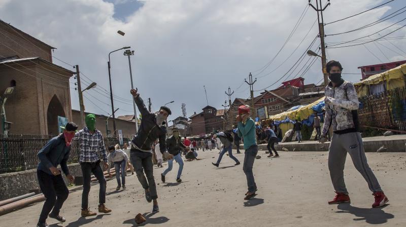 Kashmiri protesters throw rocks and bricks at forces during a protest in Srinagar. (Photo: AP)