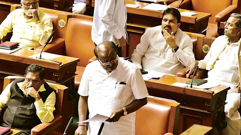 Former CM Siddaramaiah listens in rapt attention as Chief Minister H.D. Kumaraswamy speaks at the joint session of the legislature in Bengaluru on Monday (Photo: KPN )