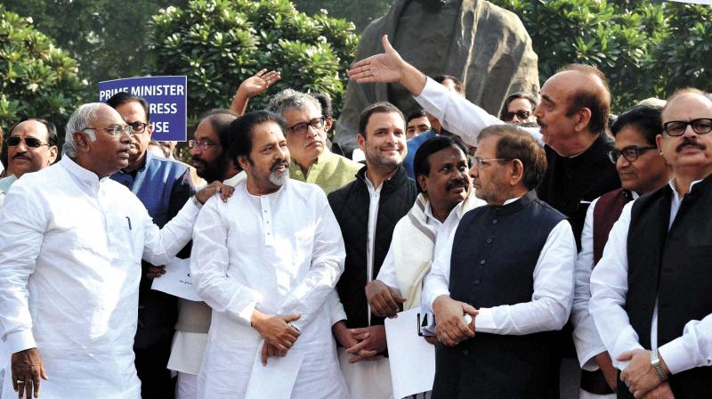 Opposition members form a human chain during a protest against the demonetization of 500 and 1,000 notes at Parliament house in New Delhi on Wednesday. Over 200 MPs from 14 parties including the AIADMK which remained silent on the issue, joined the protest. The parties decided to observe a nationwide protest day on November 28. (Photo: PTI)