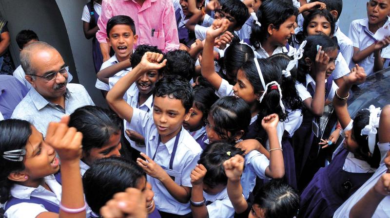 Students of Malaparamba AUP School and Pradeep Kumar, MLA, express their joy after the High Court order favouring them on Wednesday. (Photo: VENUGOPAL)