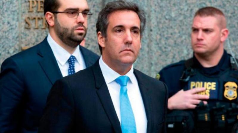 Cohen (C) did not name Trump in court, but his lawyer, Lanny Davis, said afterward he was referring to the president. (Photo: AP)