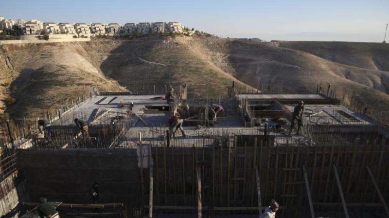 Palestinian laborers work at a construction site in the Israeli settlement of Maale Adumim, near Jerusalem. (Photo: AP)