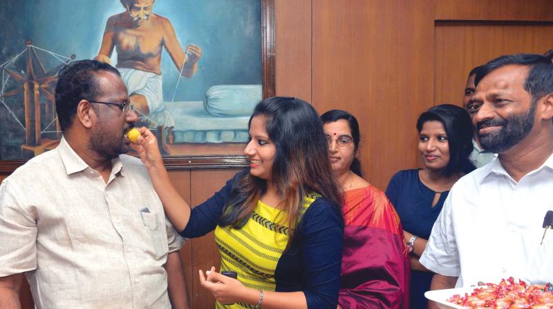 C.N. Mohanan, new Greater Cochin Development Authority (GCDA) chairman, gets sweets from his daughter after his taking charge on Monday. (Photo: DC)