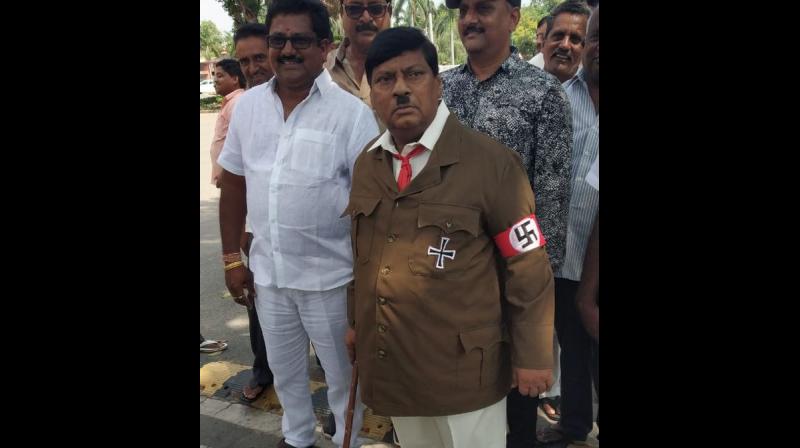 TDP MP Naramalli Sivaprasad - donning a Nazi uniform, toothbrush moustache and a stick in hand - enacted Adolf Hitler while urging his fellow party members to take a stand against the Centre. (Photo: Twitter | ANI)