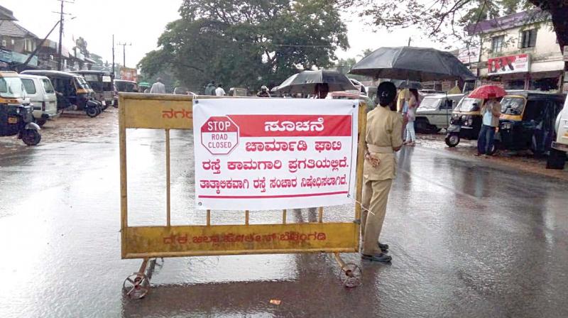 A road barricade asking people to take a diversion which was put up due to five landslides, at Ujjire, Belthangady Taluk, in the foothills of Charmadi Ghat on Wednesday  (Image: DC)
