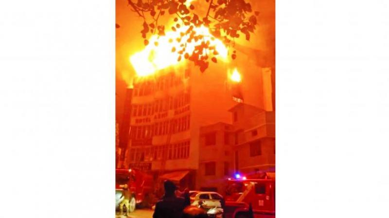 Flames rise from a hotel that caught fire in the early hours of Tuesday in New Delhi. (Photo: PTI)