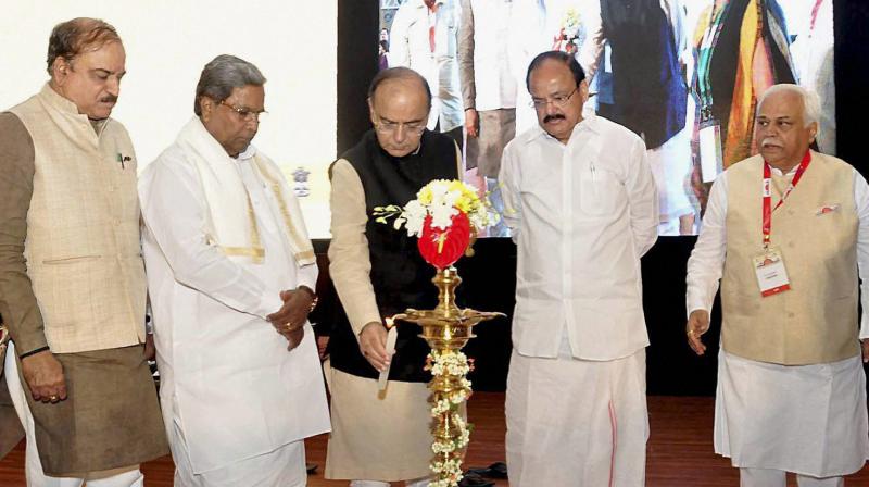 Finance Minister Arun Jaitley along with Union ministers Venkaiah Naidu and Ananth Kumar and Karnataka Chief Minister Siddharamaiah lighting lamps during inaugural session of Make In India conference in Bengaluru. (Photo: PTI)