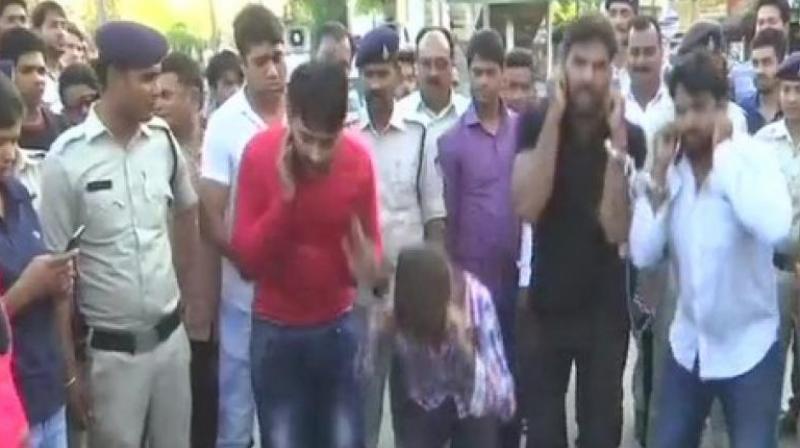 The accused were paraded through busy streets, and some women among the onlookers were seen thrashing them. (Photo: ANI)