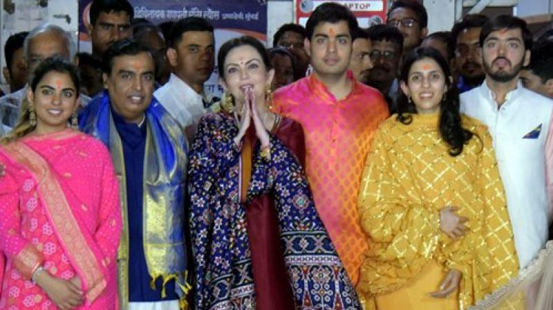 The Ambani family during their visit to Mumbais Siddhivinayak Temple on Sunday after an engagement ceremony of billionaire Mukesh Ambanis eldest son Akash Ambani to Shloka Mehta in Goa. The newly engaged couple are reported to be married later this year. (Photo: PTI)