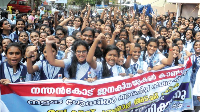 Students of Holy Angels ISC School holding a demonstration demanding the closure of newly-opened Beverages Corporation liquor outlet on the Nalanda Road, in Thiruvananthapuram on Thursday. (Photo: DC)