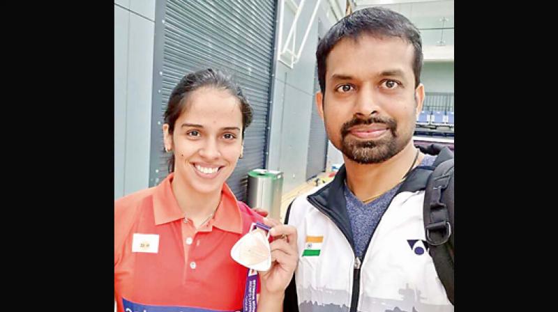 Saina Nehwal is all smiles as she shows her bronze medal in this selfie taken with Gopi at the recent World Championships in Glasgow, Scotland.