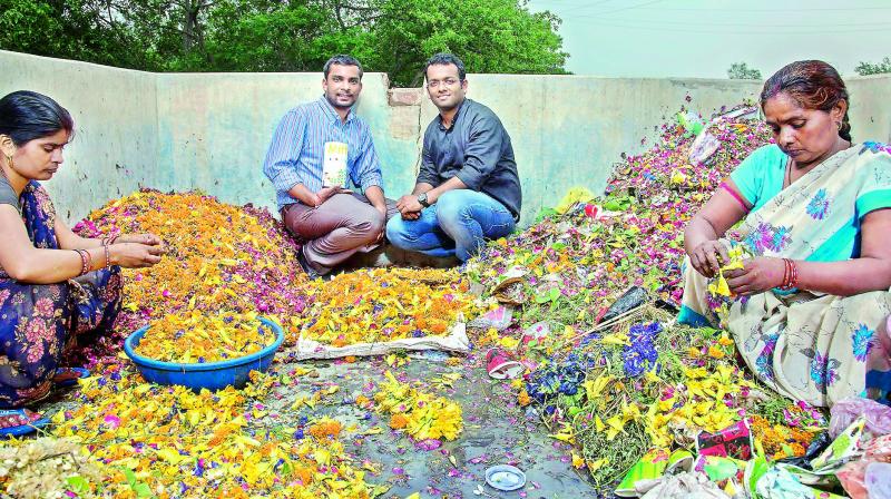 Ankit and Karan pose amidst flowers collected from temples.