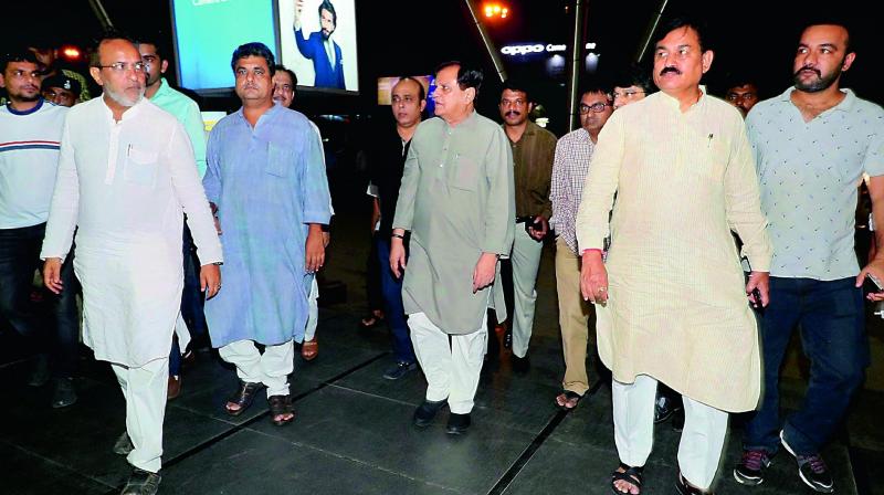 Congress leaders Bharatsinh Solanki, Arjun Modhwadia, Ahmed Patel at Ahmedabad airport to receive the partys MLAs from Karnataka on Monday. (Photo: PTI)