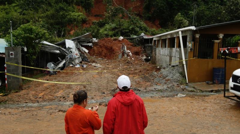 Civil Defense workers look the area where a couple was killed after their home was destroyed by a mudslide in Arraijan on the outskirts of Panama City. (Photo: AP)